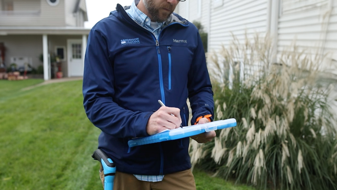 How Much Does a Sprinkler System Cost in Michigan Estimator quoting a sprinkler installation